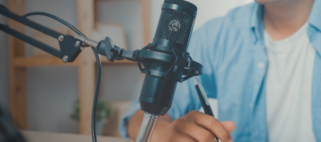 Image of a person with a podcast microphone